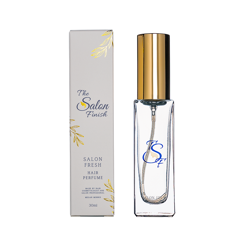 Hair perfume bottle with gold cap and clear container, accompanied by its packaging on a white background.